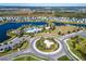 Aerial view of a Primary-planned community featuring a large community pool, lakes, and lush landscaping at 9152 Warm Springs Cir, Parrish, FL 34219