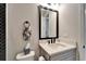 Cozy half bathroom with herringbone tile accent, toilet and sink with large mirror at 9152 Warm Springs Cir, Parrish, FL 34219