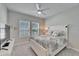 Bright bedroom with large windows, ceiling fan and bed dressed with coral patterned linens at 9152 Warm Springs Cir, Parrish, FL 34219