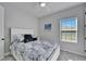 Cozy bedroom featuring a queen bed, soft carpet, and natural light from the window at 9152 Warm Springs Cir, Parrish, FL 34219