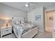 Cozy bedroom featuring a bed, a nightstand with lamp, white carpet, and a ceiling fan at 9152 Warm Springs Cir, Parrish, FL 34219