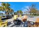 Inviting fire pit area with Adirondack chairs, perfect for relaxing and enjoying the lakeside views at 9152 Warm Springs Cir, Parrish, FL 34219