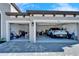 Spacious three-car garage, featuring modern doors and epoxy floors at 9152 Warm Springs Cir, Parrish, FL 34219