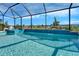 Beautiful in ground swimming pool inside a screened enclosure with serene waterfalls feature at 9152 Warm Springs Cir, Parrish, FL 34219