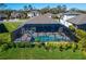 Aerial view of a home with screened-in pool, providing a private oasis with ample space for relaxation at 9152 Warm Springs Cir, Parrish, FL 34219