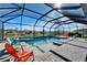 Inviting screened pool area with a spa, waterfall feature and patio chairs at 9152 Warm Springs Cir, Parrish, FL 34219