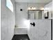 A tiled shower with built-in bench, rainfall showerhead and glass partition provides a luxurious bathing experience at 9152 Warm Springs Cir, Parrish, FL 34219
