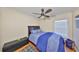 Bedroom with dark wood trim, and ceiling fan has hardwood floors and a large window at 12427 Adventure Dr, Riverview, FL 33579