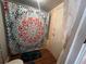 Bathroom area with toilet and colorful shower curtain for privacy at 1319 Vance Rd, Plant City, FL 33566