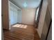 Bedroom featuring wood floors, a built-in closet, and natural light through the window at 1319 Vance Rd, Plant City, FL 33566