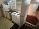 A basic kitchen with a gas range and refrigerator, viewed through an open doorway at 1319 Vance Rd, Plant City, FL 33566