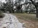 Scenic view of a land parcel with mature trees, accessible pathways, and natural vegetation at 1319 Vance Rd, Plant City, FL 33566