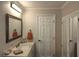 Bathroom with stone countertop vanity, framed mirror and a large white door at 1330 70Th N St, St Petersburg, FL 33710