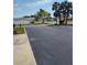 Open parking lot near buildings and tropical trees, ideal for easy access at 1330 70Th N St, St Petersburg, FL 33710