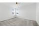 Neutral bedroom features two windows with blinds, ceiling fan, neutral paint, and carpeted flooring at 32317 Rosewood Meadow Ln, Wesley Chapel, FL 33543