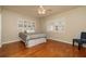 Bedroom with hardwood flooring, ceiling fan and large windows bringing in ample natural light at 1608 Pinellas Rd, Belleair, FL 33756