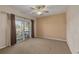 Bedroom with brown carpet, ceiling fan, and sliding doors that lead to an outdoor balcony area at 238 71St Ave, St Pete Beach, FL 33706