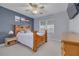 Comfortable bedroom features neutral paint, natural light, a ceiling fan, and a wooden furniture set at 238 71St Ave, St Pete Beach, FL 33706