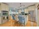 Gourmet kitchen features an island with blue countertops, stainless steel appliances, and plenty of counter space at 238 71St Ave, St Pete Beach, FL 33706