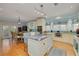 Well-appointed kitchen features an island with stainless sink, white cabinetry, and open views to the breakfast nook at 238 71St Ave, St Pete Beach, FL 33706
