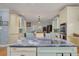 Modern kitchen with stainless steel sink, blue island countertop, and views to the dining area at 238 71St Ave, St Pete Beach, FL 33706