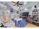 Cozy living room with high ceilings, ceiling fan, hardwood floors, and comfortable furniture at 238 71St Ave, St Pete Beach, FL 33706