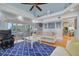 Open-concept living area boasts a large sliding glass door to balcony, light-colored sofa, and a plush blue rug at 238 71St Ave, St Pete Beach, FL 33706