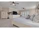 Spacious main bedroom with white furnishings, carpeted floors, ceiling fans and access to the balcony at 238 71St Ave, St Pete Beach, FL 33706