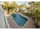 Inviting private backyard pool is surrounded by lush landscaping and a brick patio at 238 71St Ave, St Pete Beach, FL 33706