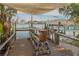 Waterfront dock area with a bar for entertaining, boat lift and seating at 238 71St Ave, St Pete Beach, FL 33706