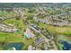 An aerial view showcases the community, golf course, swimming pool, and surrounding landscape at 11021 Edge Park Dr, Hudson, FL 34667