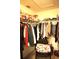 This walk-in closet features custom shelving, hanging rods, and overhead storage at 11021 Edge Park Dr, Hudson, FL 34667