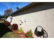 Home's exterior displaying well maintained landscaping and hose hookup at 11021 Edge Park Dr, Hudson, FL 34667