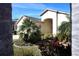 View of the front of a home with mature palm trees and tropical landscaping at 11021 Edge Park Dr, Hudson, FL 34667