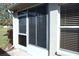 Exterior features enclosed patio with windows and a door at 11021 Edge Park Dr, Hudson, FL 34667