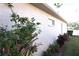 Exterior view of home showing a stucco wall with window and greenery at 11021 Edge Park Dr, Hudson, FL 34667