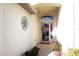 Covered entryway with front door featuring decorative wreath, welcome mat and accent decor at 11021 Edge Park Dr, Hudson, FL 34667