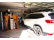 Attached garage with storage space, and a parked car at 11021 Edge Park Dr, Hudson, FL 34667