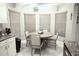 Eat-in kitchen featuring center island, stainless appliances, granite counters and ample lighting at 11021 Edge Park Dr, Hudson, FL 34667