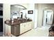 Kitchen with granite countertops, stainless steel appliances, white cabinets and tiled floors at 11021 Edge Park Dr, Hudson, FL 34667
