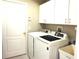 This laundry room has lots of cabinets, a new washer and dryer, and a utility sink at 11021 Edge Park Dr, Hudson, FL 34667