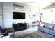 Comfortable living room featuring modern entertainment center, neutral color palette and decorative rug at 11021 Edge Park Dr, Hudson, FL 34667