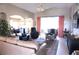 Bright and airy living room featuring vaulted ceilings, comfortable seating, and modern decor at 11021 Edge Park Dr, Hudson, FL 34667