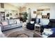 Spacious living room with a view of the dining and kitchen areas, featuring an area rug and comfortable seating at 11021 Edge Park Dr, Hudson, FL 34667