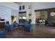 A spacious lobby area with comfortable blue armchairs, dark wood floors, and elegant decor features at 11021 Edge Park Dr, Hudson, FL 34667