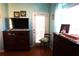 Bedroom showcasing wood laminate floors, dresser, and a door to the outside at 11021 Edge Park Dr, Hudson, FL 34667