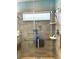 Modern walk-in shower with showerhead, handrails, and shower bench at 11021 Edge Park Dr, Hudson, FL 34667