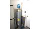 Utility room of home containing hot water heater, storage, and access to outside at 11021 Edge Park Dr, Hudson, FL 34667