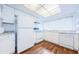 Well-lit kitchen featuring wood floors, white appliances, and light countertops at 11805 Northtrail Ave, Temple Terrace, FL 33617