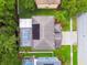 Aerial view of home showcasing pool, solar panels, and landscaping at 15815 Muirfield Dr, Odessa, FL 33556